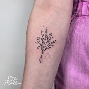 Beautiful and delicate bouquet of flowers tattooed in fine line style by Chloe Mickham.