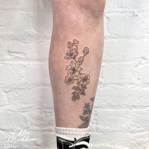 Get a stunning flower tattoo done by Chloe Mickham in fine line and illustrative style for a touch of elegance.