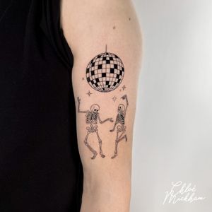 Get down with Chloe Mickham's fine-line and illustrative tattoo featuring a funky disco ball and a groovy dancing skeleton.