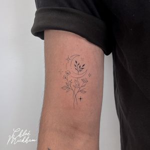 Elegant fine line design featuring a moon and flower motif by Chloe Mickham. Delicate and sophisticated.