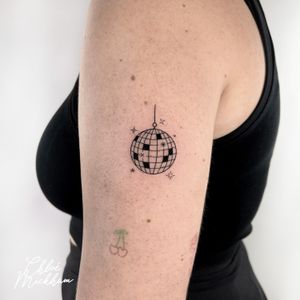 Get groovy with this stunning fine line disco ball tattoo by renowned artist Chloe Mickham. Perfect for anyone who loves to dance the night away.