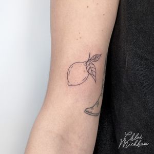 Elevate your ink game with this fine-line lemon tattoo. The intricate details and vibrant colors will make this citrus fruit pop on your skin. Book an appointment with the talented Chloe Mickham today!