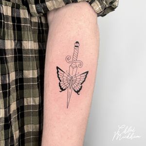 Beautifully detailed fine line tattoo by Chloe Mickham featuring a delicate butterfly and a sharp dagger motif.
