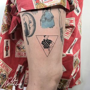 This fine line, illustrative tattoo by Chloe Mickham features a stylish woman silhouette inside a geometric triangle motif.