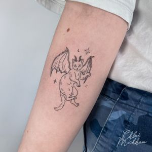 Express your edgy side with this intricate fine line tattoo featuring a devil cat design, done by the talented artist Chloe Mickham.