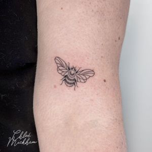Get a beautifully detailed and dainty bee tattoo with fine line work by Chloe Mickham, perfect for a subtle and elegant touch of nature.