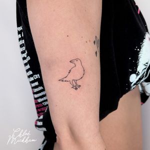 Elegant fine line tattoo of a bird crow outline by talented artist Chloe Mickham. Perfect for minimalist tattoo lovers.