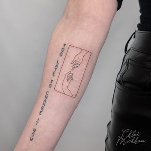 Elegant fine line tattoo featuring a frame and hands, expertly done by top artist Chloe Mickham. Perfect for those looking for a delicate and sophisticated tattoo design.