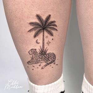 Capture the wild spirit with this illustrative tattoo by Chloe Mickham, featuring a leopard and palm tree in delicate fine line style.