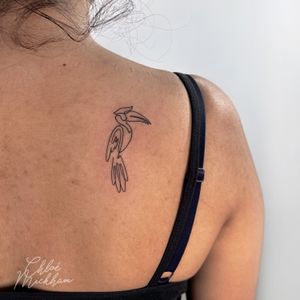 Sleek and minimalistic tattoo of a toucan done in single line style by talented artist Chloe Mickham.