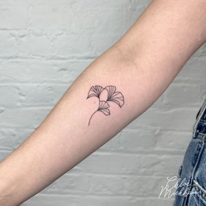 Adorn your skin with a stunning fine line flower tattoo by Chloe Mickham, showcasing intricate details and subtle beauty.