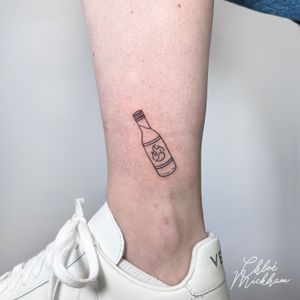 Get inked with a trendy fine line tattoo of a chilli and hot sauce bottle by tattoo artist Chloe Mickham! Spice up your body art collection today.