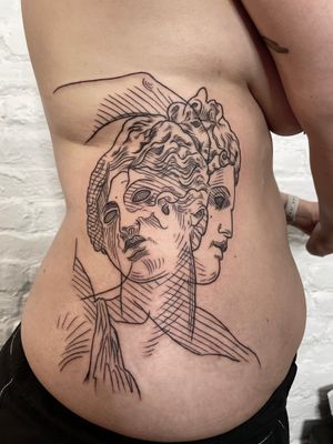 Elegant and detailed fine line tattoo of a man statue, expertly inked by Ermis Atzemoglou on the ribs.