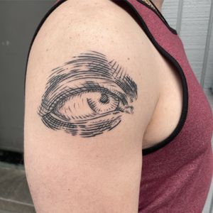 Get mesmerized with this fine line eye tattoo on your upper arm by the talented artist, Ermis Atzemoglou.