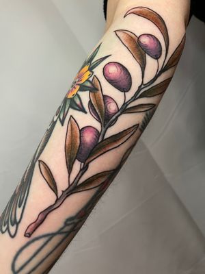 Get a stunning neo-traditional tattoo of flowers and leaves on your forearm by talented artist Ermis Atzemoglou.