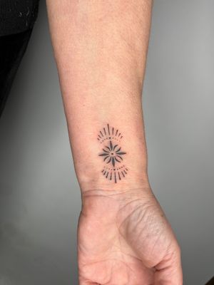 Get an intricate hand-poked ornamental pattern on your forearm by Indigo Forever Tattoos for a unique and stunning look.
