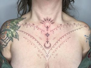 Hand-poked design by Indigo Forever Tattoos on chest, featuring detailed dotwork and ornamental motifs.
