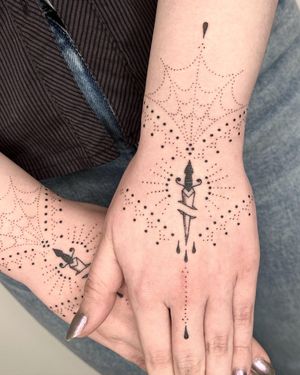 Beautiful hand_poke tattoo by Indigo Forever Tattoos featuring a dagger motif and intricate ornamental patterns.