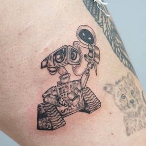 Get this heartwarming black and gray Wall-E tattoo by Nikki Bostin to showcase your love for Disney in a unique way. Perfect for any Disney fan!