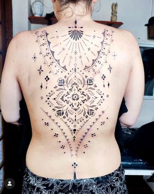 Get a stunning ornamental pattern tattoo on your back by tattoo artist Nikki Bostin. A unique and intricate design that will make a bold statement.