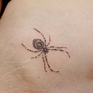 Elegant and intricate, this micro-realism spider tattoo by Nikki Bostin will make a stunning addition to your arm.
