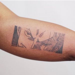 Striking blackwork tattoo of an anime man, expertly done by tattoo artist Nikki Bostin on the upper arm. Unique and impressive design.