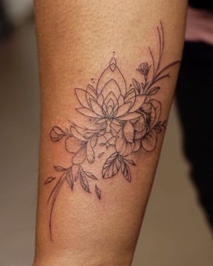 Adorn your forearm with an exquisite floral design by the talented Nikki Bostin. Delicate and refined, this tattoo is sure to make a statement.