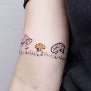 Experience the enchantment of delicate mushrooms beautifully inked on your upper arm by the talented artist Nikki Bostin.