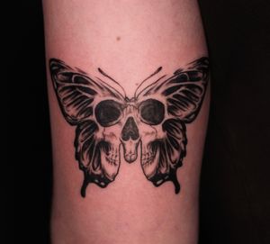 Stunning black and gray micro-realism tattoo featuring a butterfly, moth, and skull motif, beautifully executed by José.