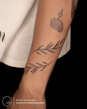 Line art leaves tattoo done by Novel Fernandez at Circle Tattoo Dadar