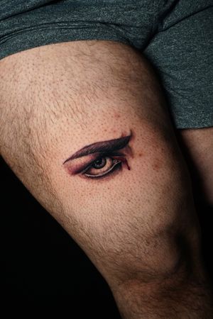 Experience the insight of Lucifer's gaze with this stunning realism tattoo on your upper leg by Miss Vampira.