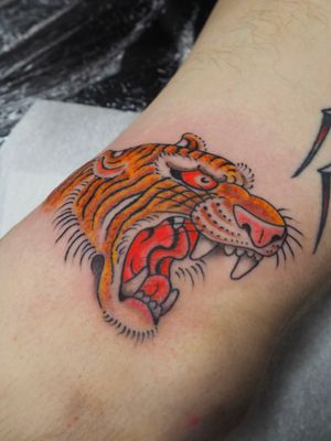 Capture the fierce beauty of a traditional Japanese tiger tattoo on your foot by Alex Travers