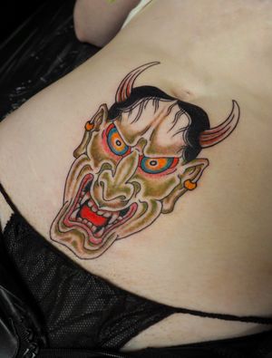 Embrace the intricate beauty of Japanese art with this haunting Hannya tattoo on your stomach, expertly done by Alex Travers.