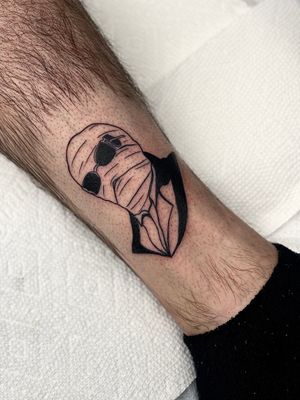 Experience the unique artistry of Miss Vampira with this stylish blackwork tattoo featuring a man wearing glasses on your lower leg.