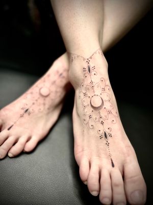 Get a stunning ornamental mandala pattern tattoo on your foot by Indigo Forever Tattoos for a unique and intricate look.