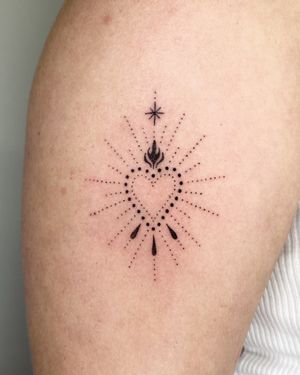 Get a unique hand-poked heart and pattern design on your upper arm by Indigo Forever Tattoos.