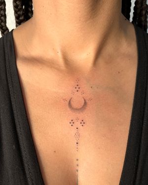Adorn your chest with a hand-poked ornamental design featuring a mystical moon motif by Indigo Forever Tattoos.