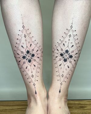 Elegant hand-poked floral and pattern design on shin by Indigo Forever Tattoos.