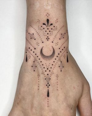 Intricate hand-poked design featuring a moon and ornamental pattern by Indigo Forever Tattoos