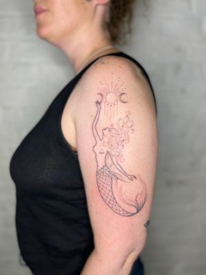 Elegant dotwork and fine line design of a mermaid and moon by Indigo Forever Tattoos. Hand-poked for a unique touch.