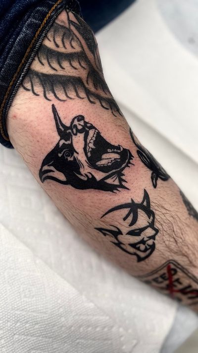 Get inked with a bold blackwork dog design by the talented Miss Vampira, perfect for your lower leg. Embrace your love for canine companions with this unique tattoo.