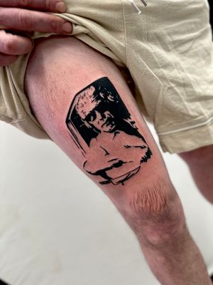 Bold and striking blackwork tattoo of a man, expertly done by the talented artist Miss Vampira on the upper leg.