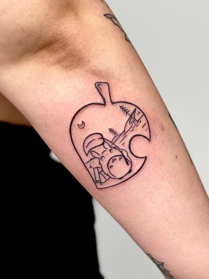 Elegant blackwork tattoo featuring the beloved character Totoro and a leaf motif, done by talented artist Miss Vampira.