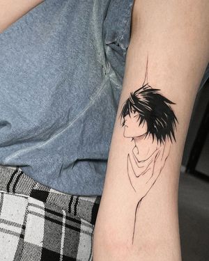 Bold blackwork forearm tattoo featuring an anime-style man, expertly executed by artist Artemis.