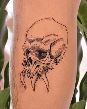 Get inked with a striking blackwork skull tattoo on your lower leg by the talented artist Hana Kaki.