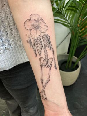 Skeleton chilling with a dandelion  