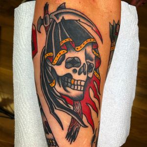 Immerse yourself in the dark world of death with this traditional tattoo by Carlos Zucato. Perfect for showcasing your macabre style.
