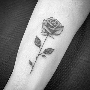 Elegant flower design in fine line style, beautifully executed on the forearm by talented artist Carlos Zucato.
