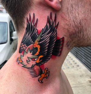 Get a striking traditional eagle tattoo on your neck by the talented artist Carlos Zucato. Make a statement with this fierce design.