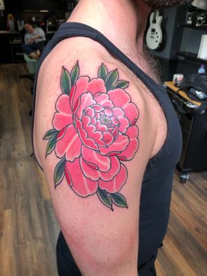 Intricate and vibrant peony flower tattoo designed by Carlos Zucato, perfect for your upper arm. Embrace the beauty of Japanese art!